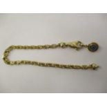 An Adler gold coloured metal, chain link bracelet set with a blue and black glass bead pendant, 7