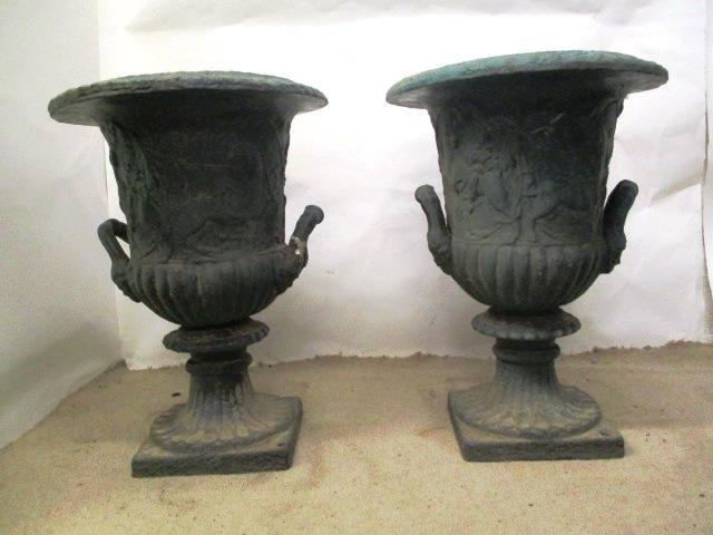 A pair of Victorian green painted, cast iron campana garden urns, with twin mask handles and