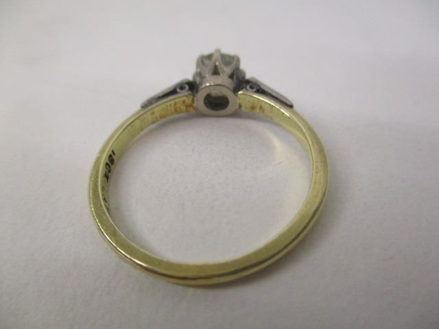 A gold and platinum coloured ring set with an oval diamond, approximately 0.65ct with four - Image 4 of 5