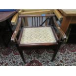 An Edwardian inlaid mahogany piano seat with upholstered hinged seat on square, tapering legs