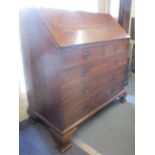 A Georgian mahogany bureau, the fall flap revealing fitting compartments and drawers above two short