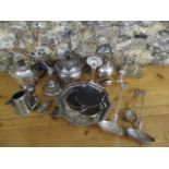 A selection of silver plate to include a teapot, a ladle and other items