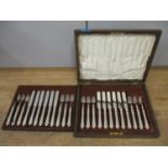 A set of twelve Mappin & Webb silver plated knives and forks in an oak case