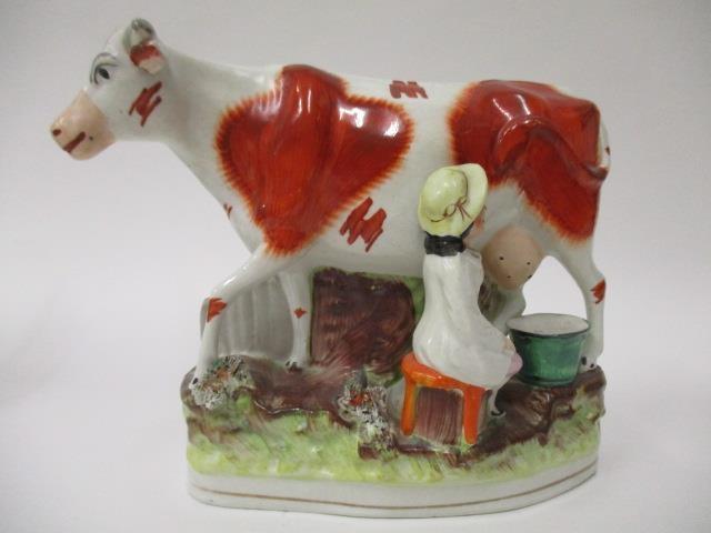 A pair of Victorian Staffordshire pottery flatback models of a boy and a girl each milking a cow, - Image 6 of 12