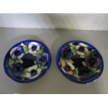 Two Walter Moorcroft pottery Pansy pattern plates, tube lined in purple, red, blue and white flowers