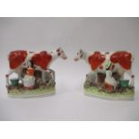 A pair of Victorian Staffordshire pottery flatback models of a boy and a girl each milking a cow,