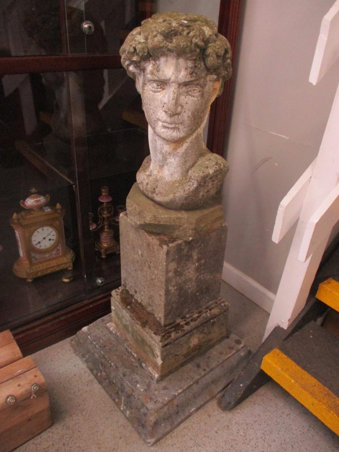 A stoneware bust of David raised on square bases