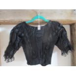 A Victorian ladies black silk, lace and sequin blouse with hook and eye fastening to the back