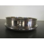 Brian Leslie Fuller b 1937 - a modernist silver and wooden wine coaster with reeded top edge,