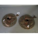 A pair of copper Arts & Crafts, Newlyn style chambersticks with embossed decoration of four fish,