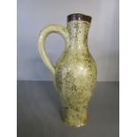 A Martin Bros stoneware jug by Robert Wallace Martin decorated with fine brown spots on a creamy