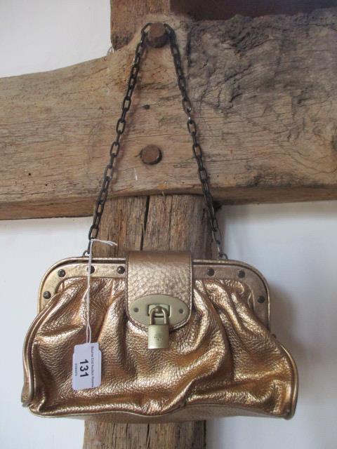 A Mulberry leather and metal gold coloured shoulder bag, serial number 060652, 9"w x 5"h, having a