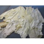 A quantity of Victorian ladies and children's clothing to include under-garments, together with