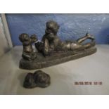 A Heredities composition bronzed figurine of a woman playing with a young child and a small model of