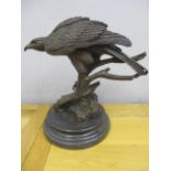 A modern cast and patinated bronze model of a Goss Hawk perched on a branch, on a plinth