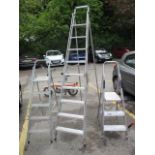 Three aluminium folding ladders, the tallest 98"h