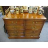 A modern mahogany four drawer filing cabinet in the form of an eight drawer chest of drawers, 30 1/