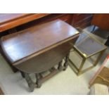 An early 20th century oak gate leg table, together with a nest of brass and glass topped tables