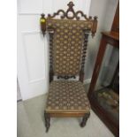 A late Victorian rosewood prie dieu chair with a tapestry upholstered back and seat, on barley twist