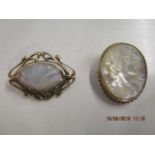 An oval carved mother of pearl brooch depicting a Dexter profile of a young lady in a 9ct yellow