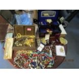 A quantity of costume jewellery to include beaded necklaces, brooches and other items