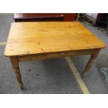 A Victorian pine dining table having a single inset drawer and turned legs, 30" h x 48"w