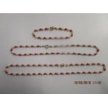 Two 9ct gold coral and pearl beaded necklaces and a matching bracelet