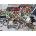 Mixed high street costume jewellery, a pink jewellery case and a small metal trunk with a