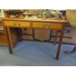 A mid 20th century mahogany desk with square, tapered legs having a brown leather scriber above
