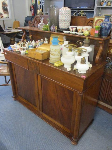 An early 29th century mahogany chiffoniere having a raised back, two drawers and two cupboard