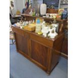 An early 29th century mahogany chiffoniere having a raised back, two drawers and two cupboard