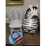 Two childrens chairs, one a painted rocking chair and the other in the form of a zebra