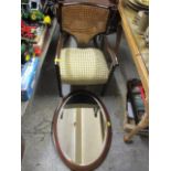 An early 20th century mahogany caned back armchair and an Edwardian inlaid mahogany mirror