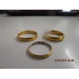 Two 22ct yellow gold wedding bands, total weight 13g and a yellow gold and platinum wedding band,