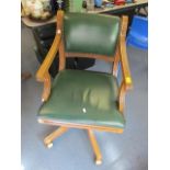 A modern green leather upholstered, button back swivel office chair