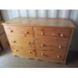 A modern large pine bank of six drawers standing on a plinth base, 40" h x 60"w