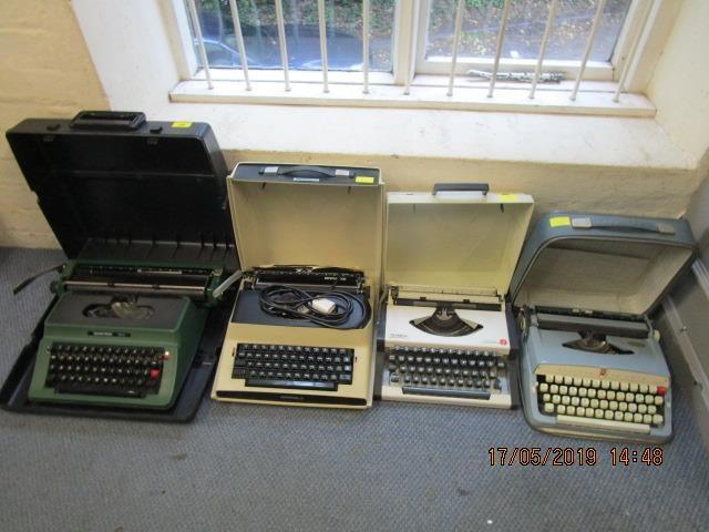 A group of four cased typewriters to include a green coloured Silver Reed 500 typewriter, an