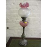 A large Victorian oil lamp having a coloured glass shade and reservoir