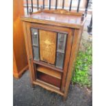 A late Victorian rosewood music cabinet having inlaid decoration, mirrored door and short tapering