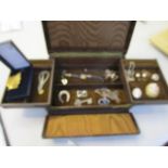 A brown leather jewellery box containing a selection of jewellery to include two shell cameo