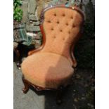 A Victorian walnut spoon and button back nursing chair