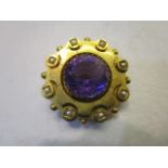 A mid Victorian yellow metal, amethyst and pearl set brooch, large central amethyst surrounded by