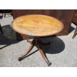 A Victorian mahogany circular topped table on four splayed legs, 21"h x 23"w