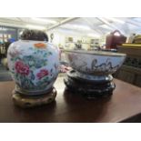 A 19th century Chinese famille rose porcelain jar with carved wooden cover A/F and stand, and a