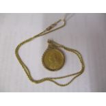 A Victorian full gold sovereign in a 9ct gold surround on a gold coloured metal necklace, stamped