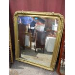 A late 19th/early 20th century gold painted mirror, having half floral decoration, 46" h x 37"w