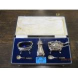 A silver cruet set in a presentation case