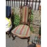 A Victorian walnut hall chair having barley twist supports and tapestry seat