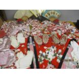 Two sets of children's Japanese outfits to include kimonos, shoes, hats, fans and tow fans depicting