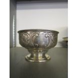 A Victorian silver footed bowl with floral repousse decoration, vacant cartouche bordered by c-